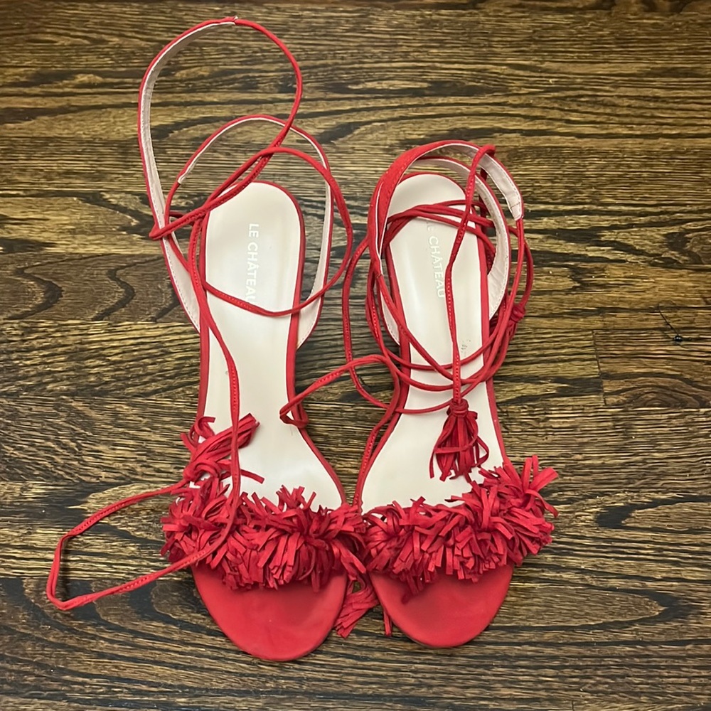 Wrap around red heels with pom-pom